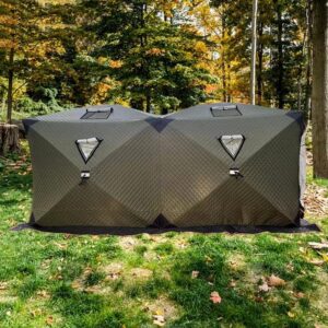 A double sauna tent set up in the woods